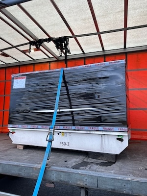 A picture of a used FG Wilson P50-3 being loaded onto a truck.